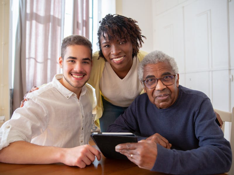 Serenity Home Care home health aide smiling with senior client in Philadelphia living room